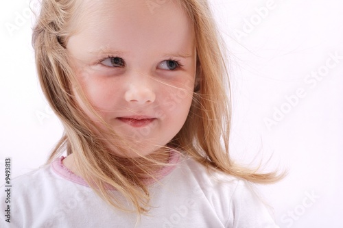 Studio portrait of cute little girl with blowing hair