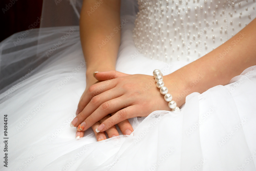 hands of fiancee are together on white dress hands of fiancee are together on white dress