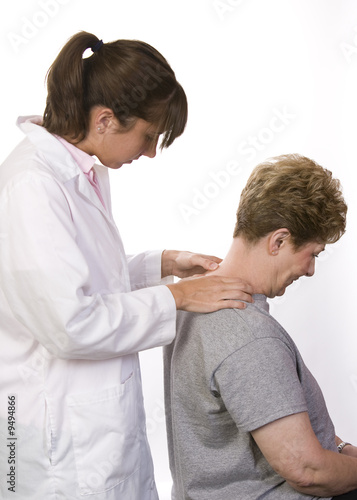 physical therapist checks a patient's spine in the neck