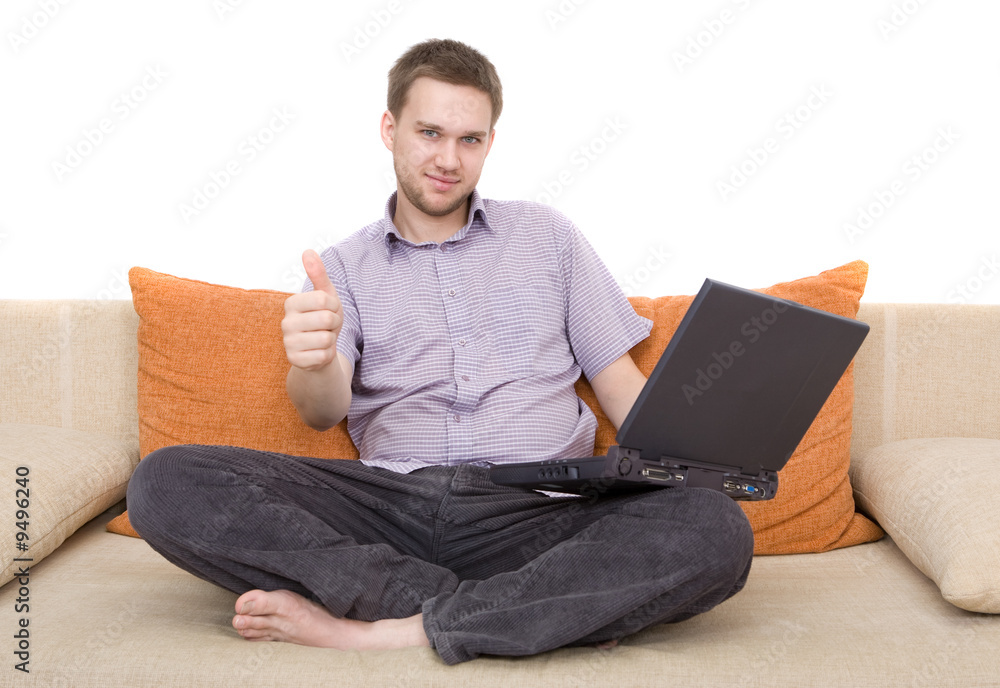 casual man sitting on sofa with laptop casual man sitting on sofa with laptop