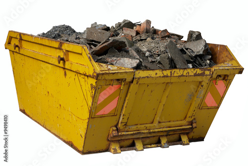 A skip full of rubble isolated over white. photo