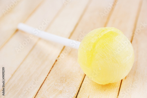 Lollipop on the wooden background © kret