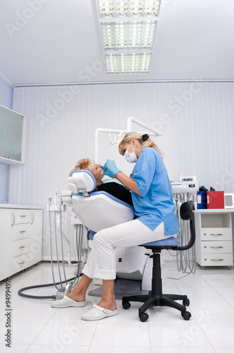 doctor works with patient in the dentist office