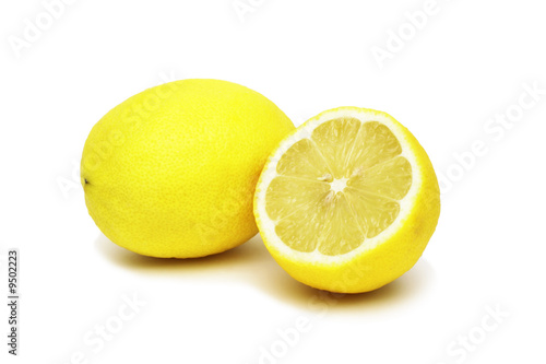 Lemon and lemon half on white background