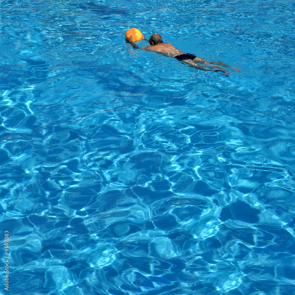 man with a ball in swimming pool