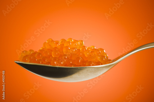 Salmon roe close up over orange background
