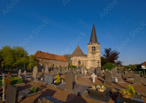 Картината върху платно graveyard on a sunny day and blue sky with  medieval church