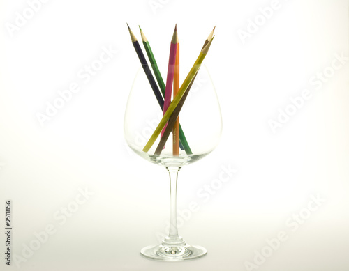 Drawing pencils in the wine glass on white