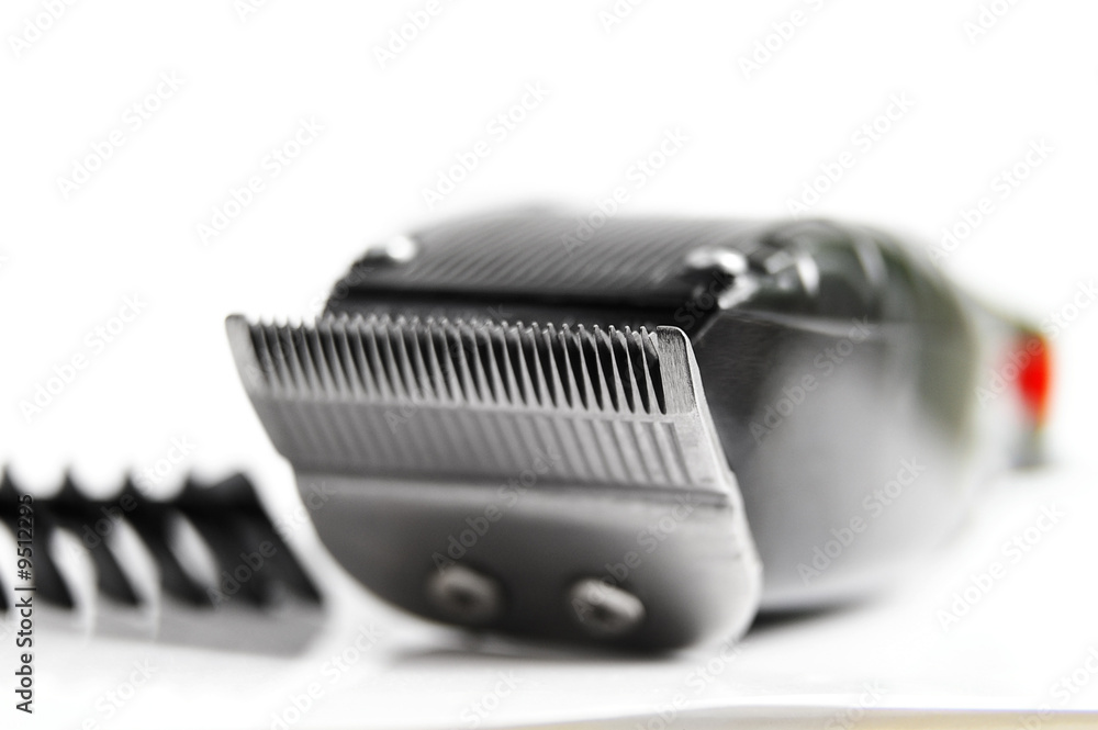 closeup of hair clippers and guide, on white closeup of hair clippers and guide, on white