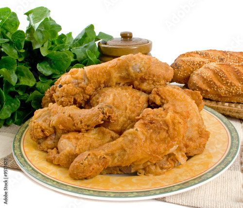 Fried chicken pieces over white background