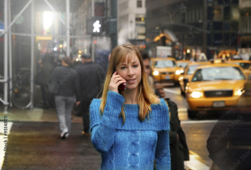 Fototapeta premium young woman walking and talking on cell phone