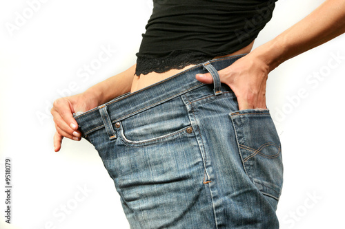 I lost weight! Woman in too large jeans.