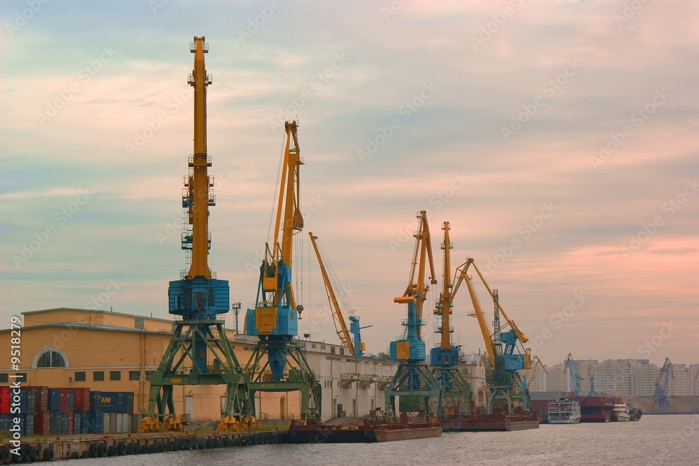 Cranes in the evening river port