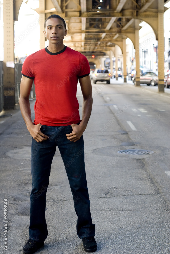 Handsome black man in red t-shirt and jeans standing Stock Photo | Adobe  Stock