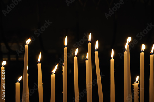 Candles in catholic church on dark background