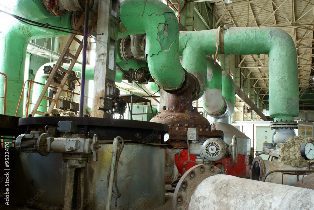 Pipes, tubes, machinery and steam turbine at a power plant Pipes, tubes, machinery and steam turbine at a power plant