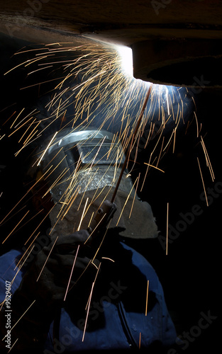 a welder working at shipyard at night