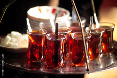 A man serving Turkish tea with a tray photo