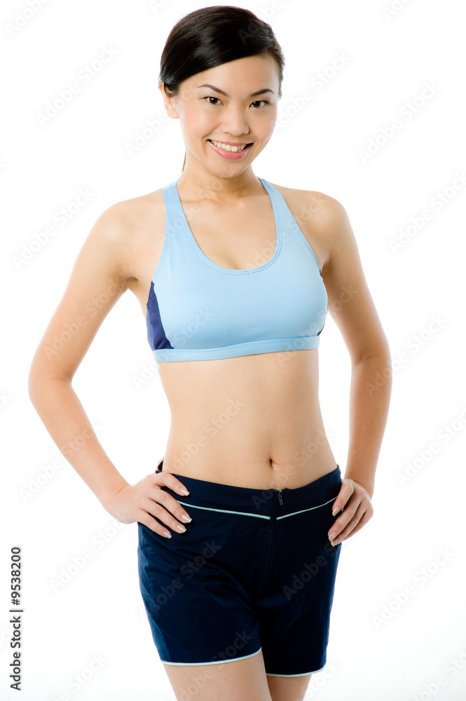 A young attractive Asian woman in sportswear on white background A young attractive Asian woman in sportswear on white background