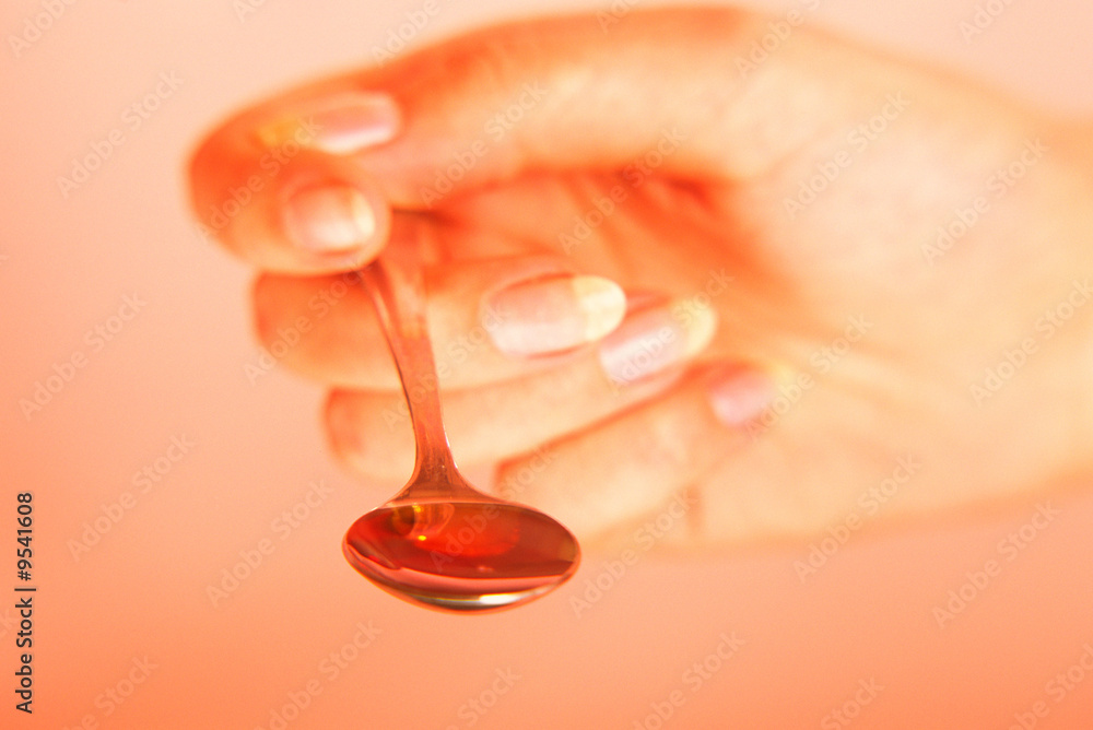 Brush of hand with spoon of medicine Brush of hand with spoon of medicine