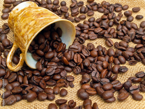 cup and spilled coffe over the linnen fabric photo