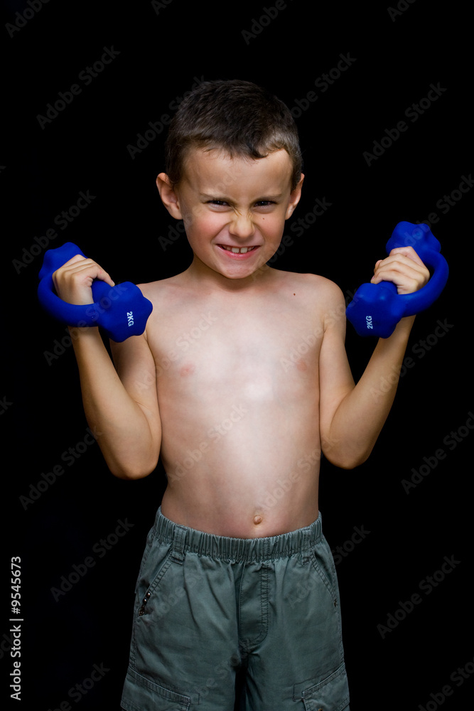 Low key portrait of a kid doing fitness Low key portrait of a kid doing fitness