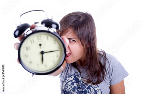 young woman with alarm clock screaming