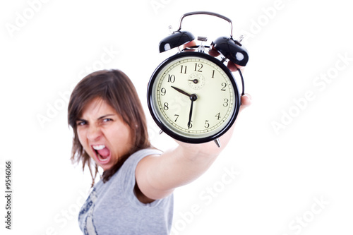 young woman with alarm clock screaming