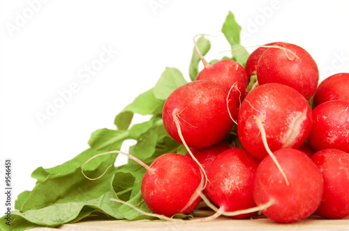 bunch of radishes on wooden plate