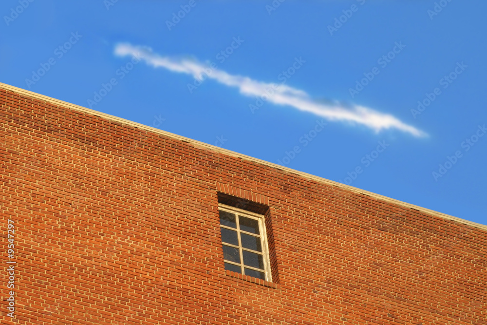 photo of brick building with blue sky