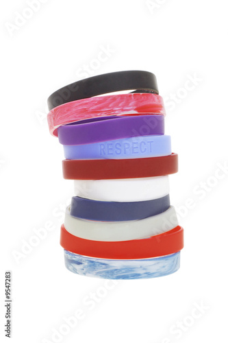 Stack of colorful wrist bands on white background