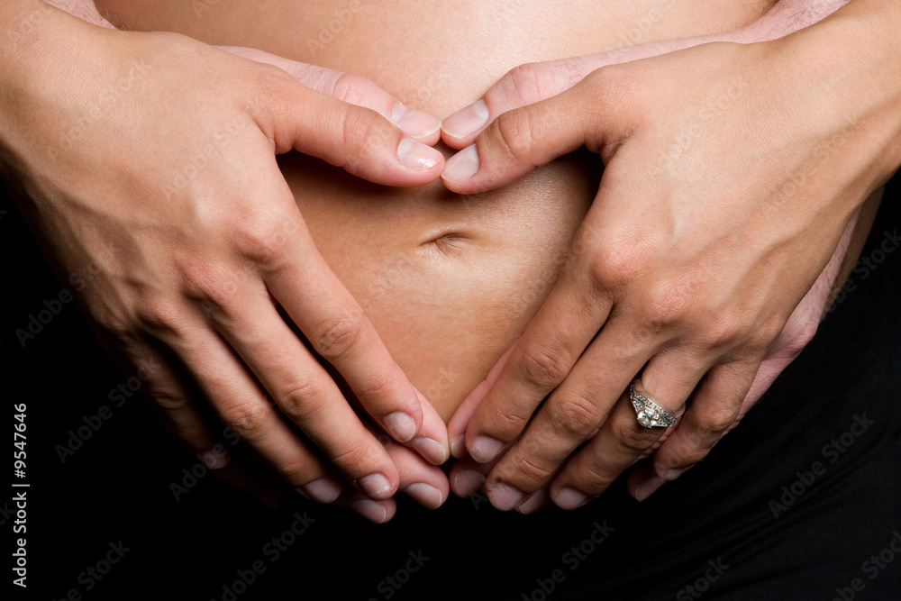 Hands Forming Heart on Pregnant Belly Hands Forming Heart on Pregnant Belly
