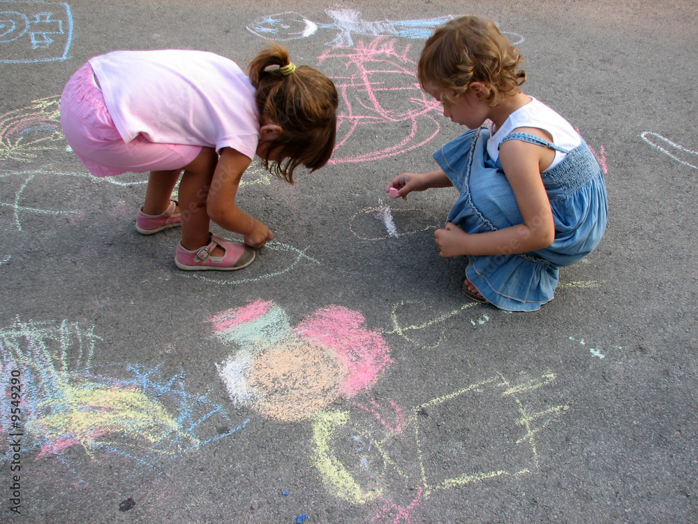 Fototapeta premium two little girls drawing on the street