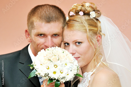 happy bride and suiter together looking at camera