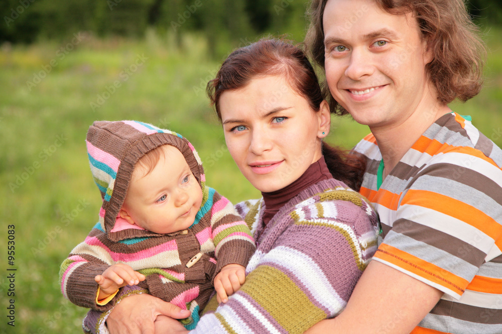family with baby in stripe clothes in park family with baby in stripe clothes in park