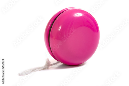 Obraz na płótnie A child's pink yo-yo on a white background with copy space