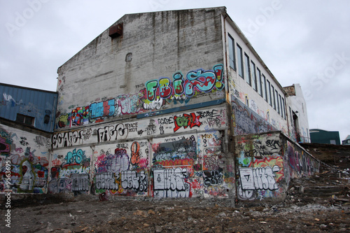 Condemned builiding during demolishion, grafiti on the walls. photo