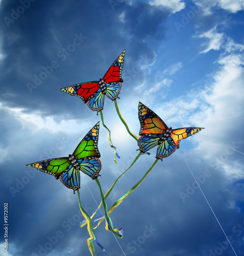 Three colorful kites at cloudy sky