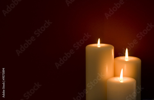 Three candles on a red background