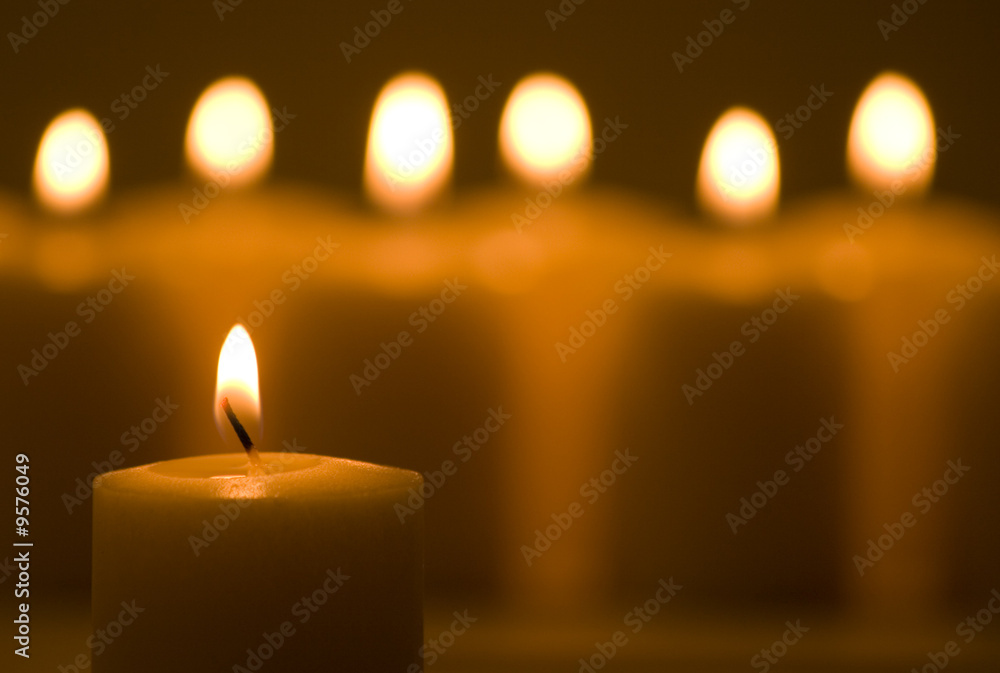 Warm glowing candles in a group