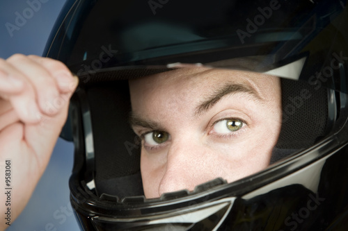Close-up of a man wearing a motorcycle helmet © Scott Griessel