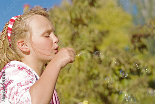 this young girl blows nice floating bubbles