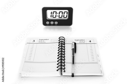 digital clock and notebook