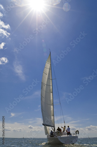 A yacht sailing on a bright sunny summer day