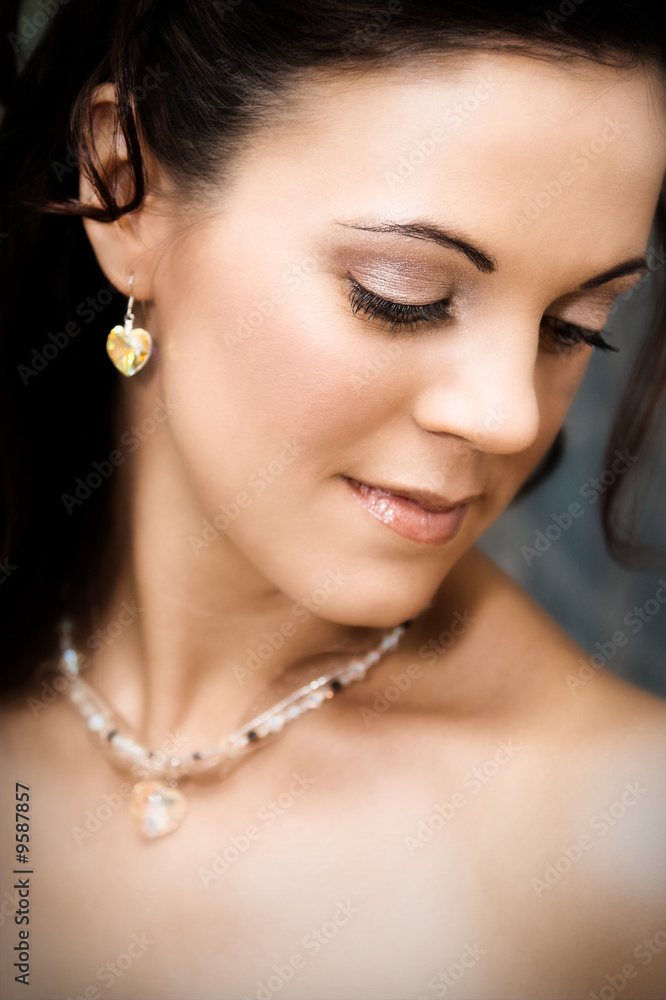 Beautiful brunette bride wearing heart shaped jewelery