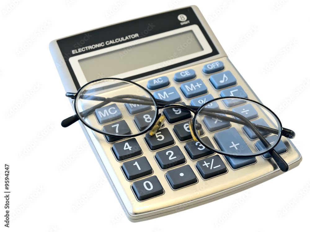 digital calculator and glasses over the white background.. digital calculator and glasses over the white background..