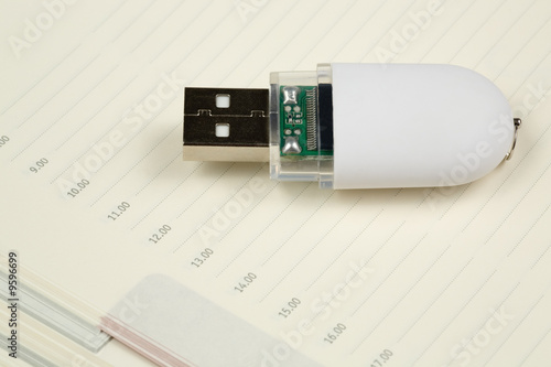 White pendrive and deily schedule photo