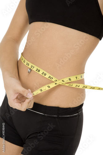 Caucasian woman measuring her waist