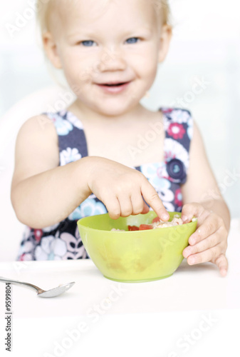 Little girl eating healthy breakfast