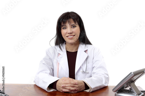 Friendly doctor confidently sits at her desk